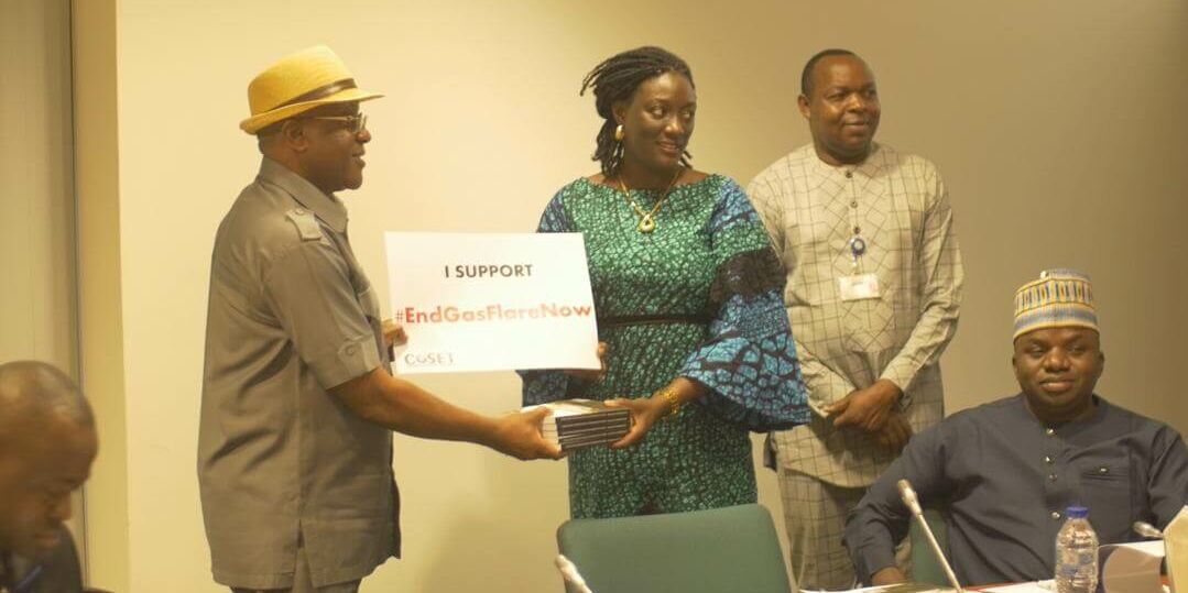 CoSET core group member, Rinmicit Temlong, presenting copies of the Climate change and socio-ecological transformation in Nigeria publication to Hon. Johnson Ogwumah, Chair, House Committee on Environment